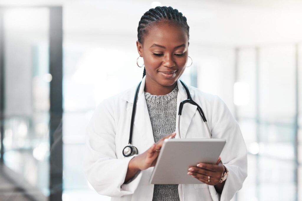 who has time to be tied down to a desk. shot of a young doctor using a digital tablet in a modern hospital.